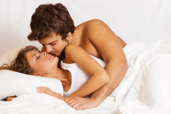 Couple embracing in bed in the morning